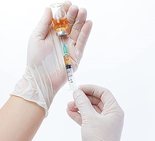 A person holding a syringe and a small bottle, wearing Diamond Clear Vinyl Exam Gloves